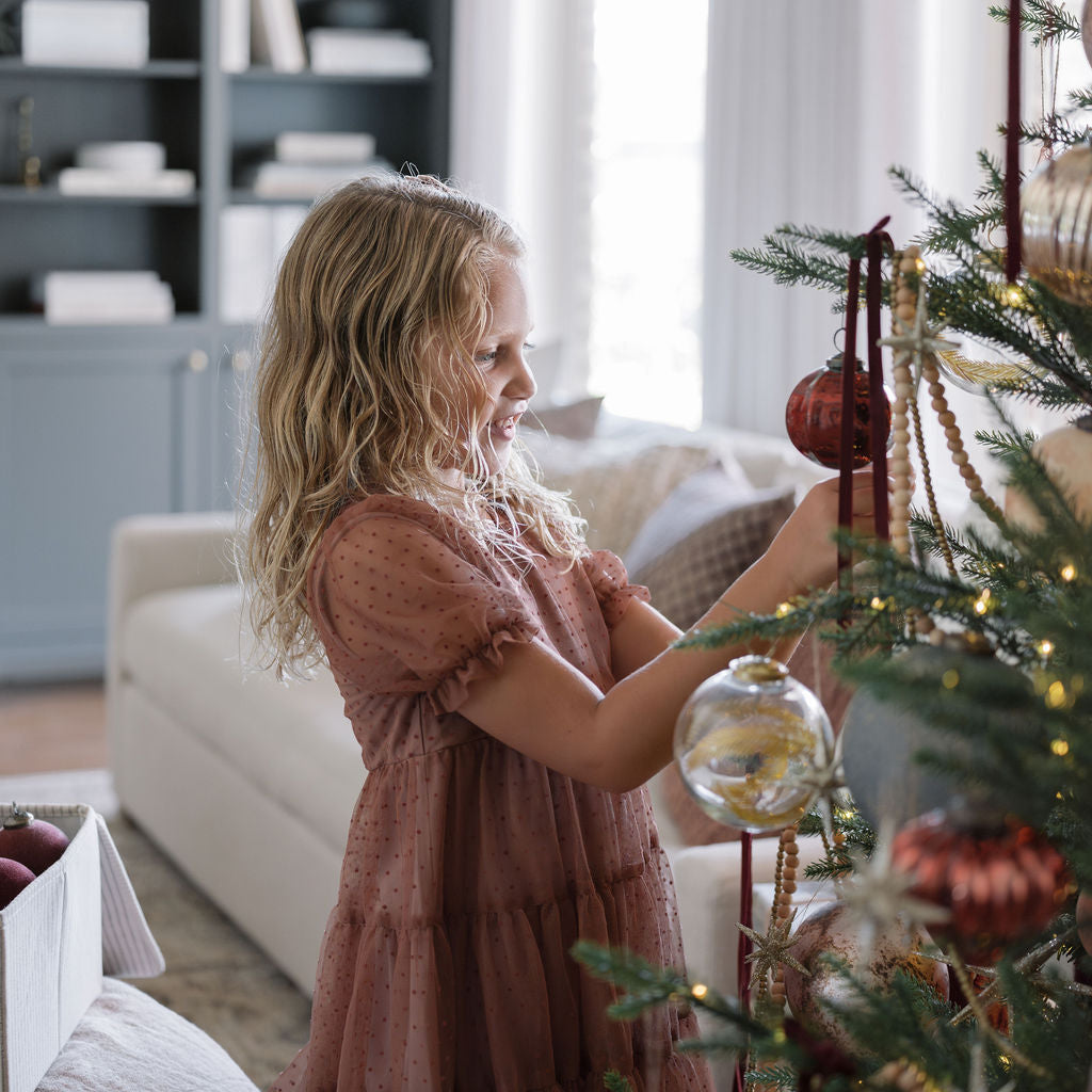 timeless tree with girl placing ornament