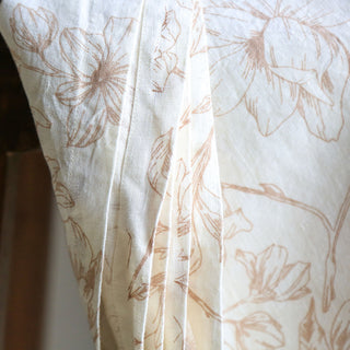 Close-up of the CG Hunter Blush Lilies Tablecloth, highlighting intricate floral details and soft blush hues, perfect for sophisticated table decor.