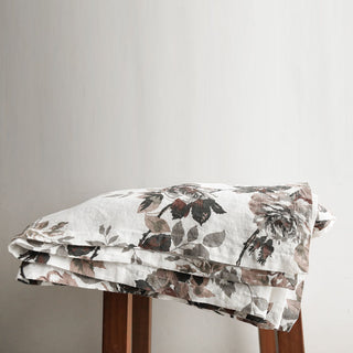Premium CG Hunter Eggplant and Grey Roses Tablecloth folded neatly, highlighting its intricate grey rose design against a refined backdrop for a luxurious dining experience.
