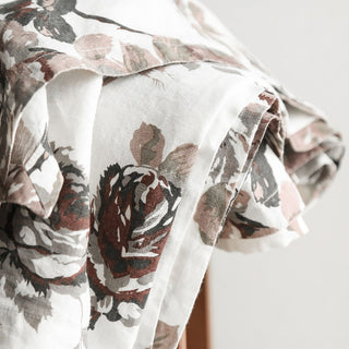 Elegant close-up of the CG Hunter Handcrafted Linen Eggplant and Grey Roses Tablecloth showcasing delicate grey rose patterns on a rich eggplant background.