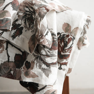 Exquisite detail of the CG Hunter Handcrafted Linen Eggplant and Grey Roses Tablecloth draped beautifully, highlighting the luxurious interplay of deep eggplant and grey tones.