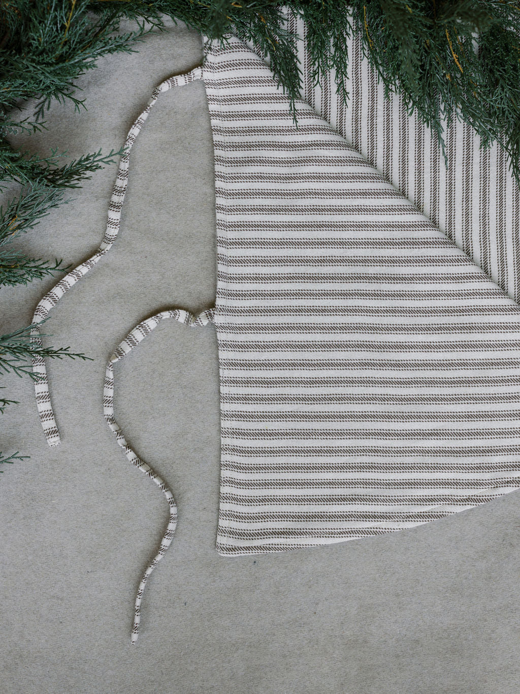 Close up of 60" Reversible Tree Skirt with a European Ticking and a Natural Wool