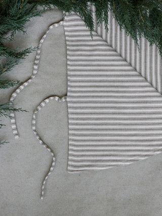 Stylish Ticking Stripe Reversible Tree Skirt by CG Hunter, featuring a cozy blend of stripes, designed to enhance the festive atmosphere under your Christmas tree.