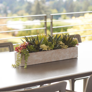 Elegant rectangular artificial succulent arrangement by CG Hunter in a stylish natural planter, enhancing luxury outdoor dining ambiance.