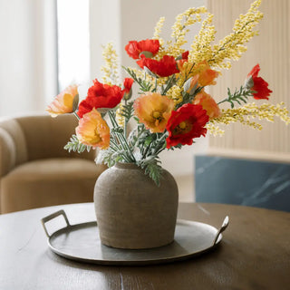 Decorative vase with flowers on a table in a living room setting
