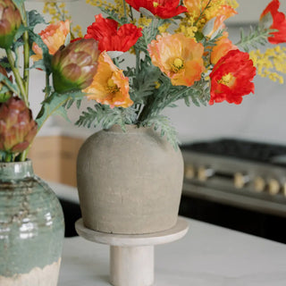 Decorative vases with flowers on a kitchen counter