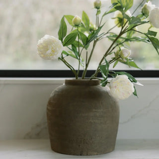 Vase with white flowers on a marble surface