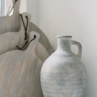 White ceramic vases with textured surfaces on a light background