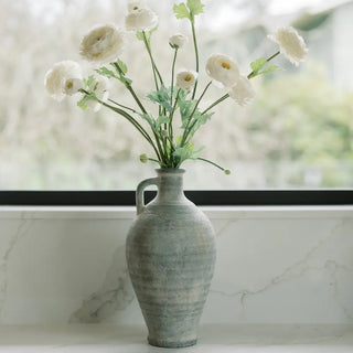 Decorative vase with white flowers on a marble surface