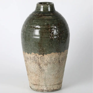 Green and beige ceramic vase on a white background