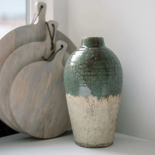 Two ceramic vases with textured surfaces on a light background