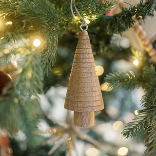 Elegant 5" Wooden Tree Christmas Ornament hanging on a Christmas tree, featuring a distinct cone shape crafted from high-quality mango wood by CG Hunter.