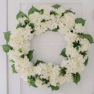 White flower wreath with green leaves on a white background
