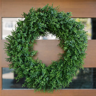 Green wreath on a wooden door with glass panels
