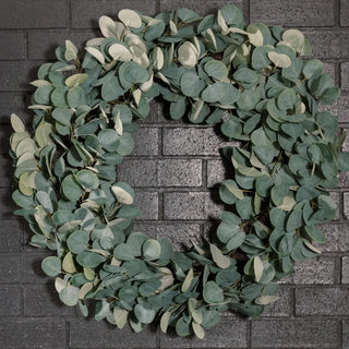 Green leafy wreath on a brick wall