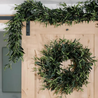 Green wreath and garland on a wooden door