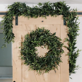 Green wreath and garland on a wooden door