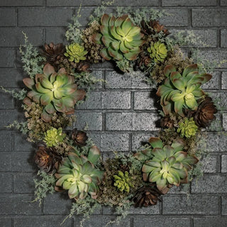 Succulent wreath against a brick wall