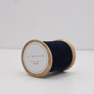 Handcrafted Wooden Spool of Narrow Hand Dyed Velvet Ribbon in Dark Blue by CG Hunter, showcasing a sumptuous texture ideal for elegant gift wrapping and DIY projects.