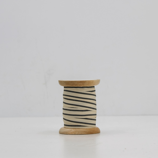 Luxurious Grosgrain Ribbon in Cream and Black by CG Hunter, elegantly wrapped around a handmade wooden spool, perfect for sophisticated gift wrapping and decor.