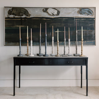 Sophisticated collection of tapered candle holders from CG Hunter, featuring dark grey wood alongside other hues, perfect for a refined home décor centerpiece.