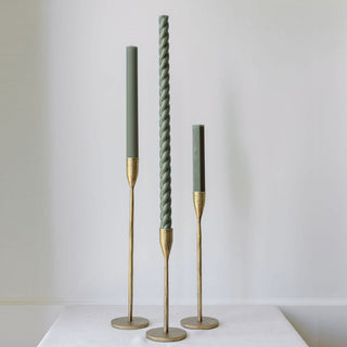 Elegant handcrafted antique brass candlesticks from CG Hunter, featuring a tall twisted candle and two tapered candles, perfect for luxurious home decor.