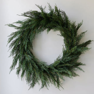 Capture the essence of sophistication with the Cedar Tree and Cedar Wreath by CG Hunter. This exquisite cedar wreath, featuring abundant greenery, offers an elegant touch to any wall or door, perfect for seasonal decor.
