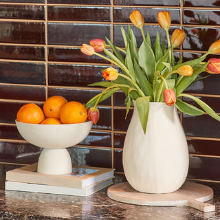 Chic Charlotte Aluminum Vases by CG Hunter, featuring a medium vase accompanied by a bowl of oranges and tulips, ideal for enhancing any kitchen or dining space.