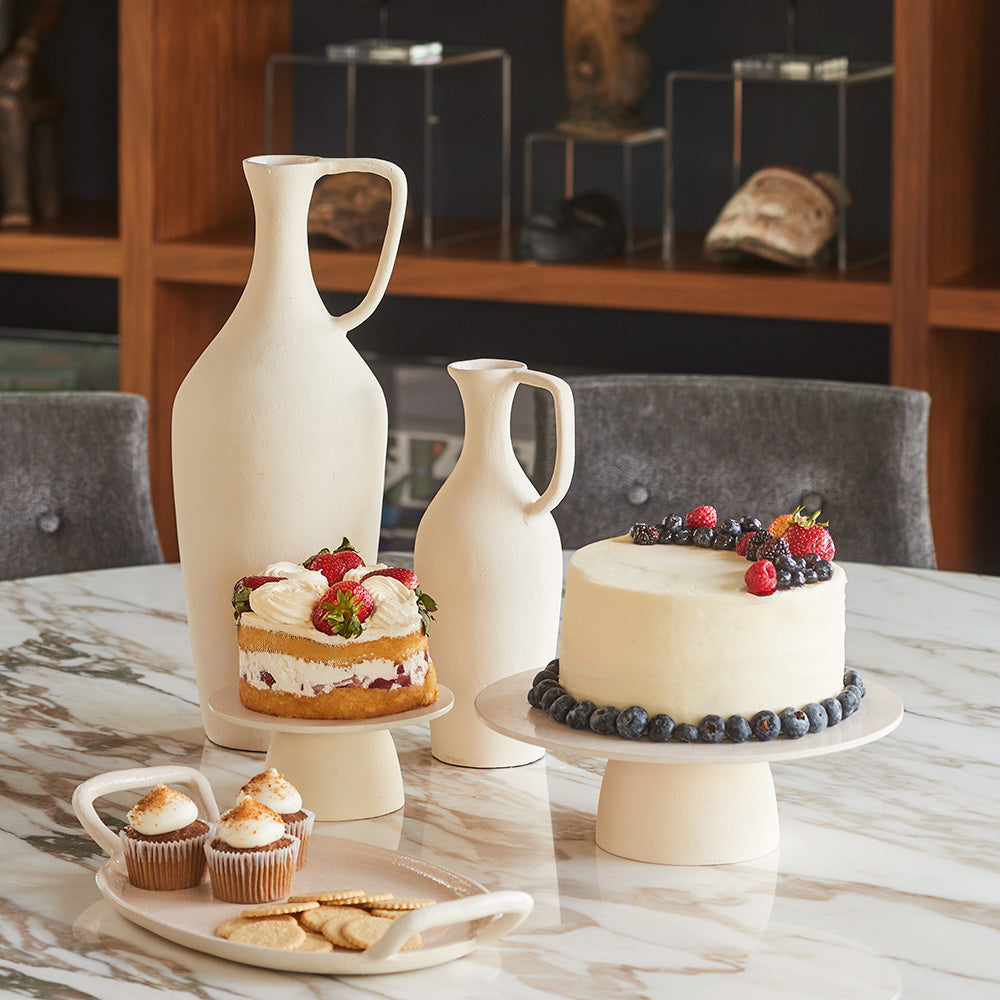 Cake Pedestals with matching pitchers and tray with food