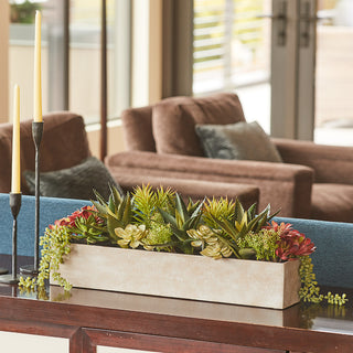 Chic artificial succulent centerpiece by CG Hunter, showcased on a console table, adding elegance to upscale living spaces.