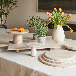 Elegant display of the Charlotte Wood Oblong Serving Board collection by CG Hunter, showcasing various artisanal pieces including serving boards and decorative elements with rustic charm.