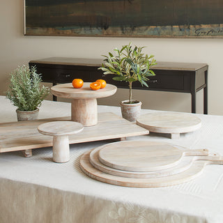 Exquisite display of multiple Charlotte Wood Cheese Boards by CG Hunter, crafted from sustainable Mango wood, enhancing modern decor with its unique shapes and textures.